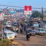 A vibrant and busy street in Kampala, Uganda, showcasing daily life and local transportation.