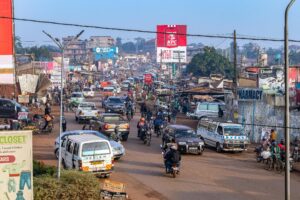 A vibrant and busy street in Kampala, Uganda, showcasing daily life and local transportation.