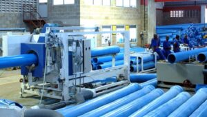Workers on a manufacturing floor inside a Ugandan factory, representing the country's industrial growth ambitions