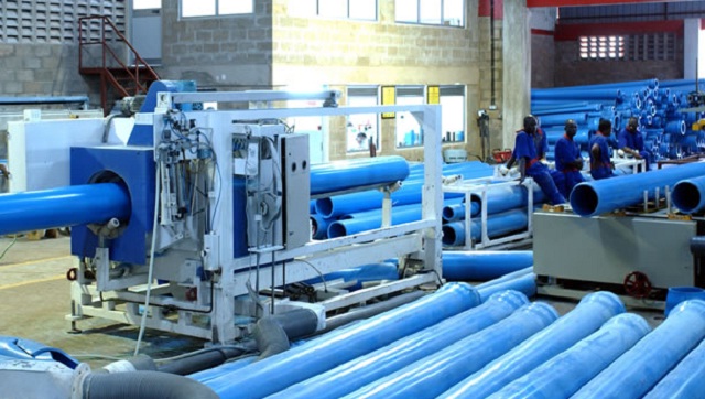 Workers on a manufacturing floor inside a Ugandan factory, representing the country's industrial growth ambitions